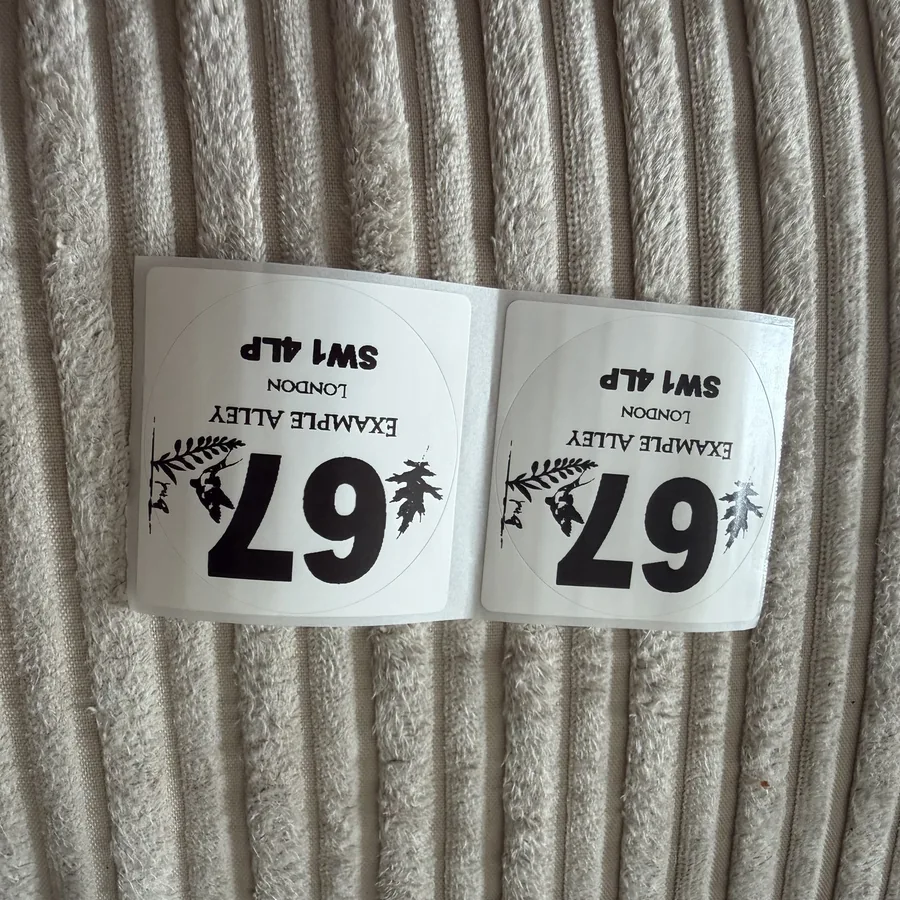 Two example wheelie bin stickers on backing paper