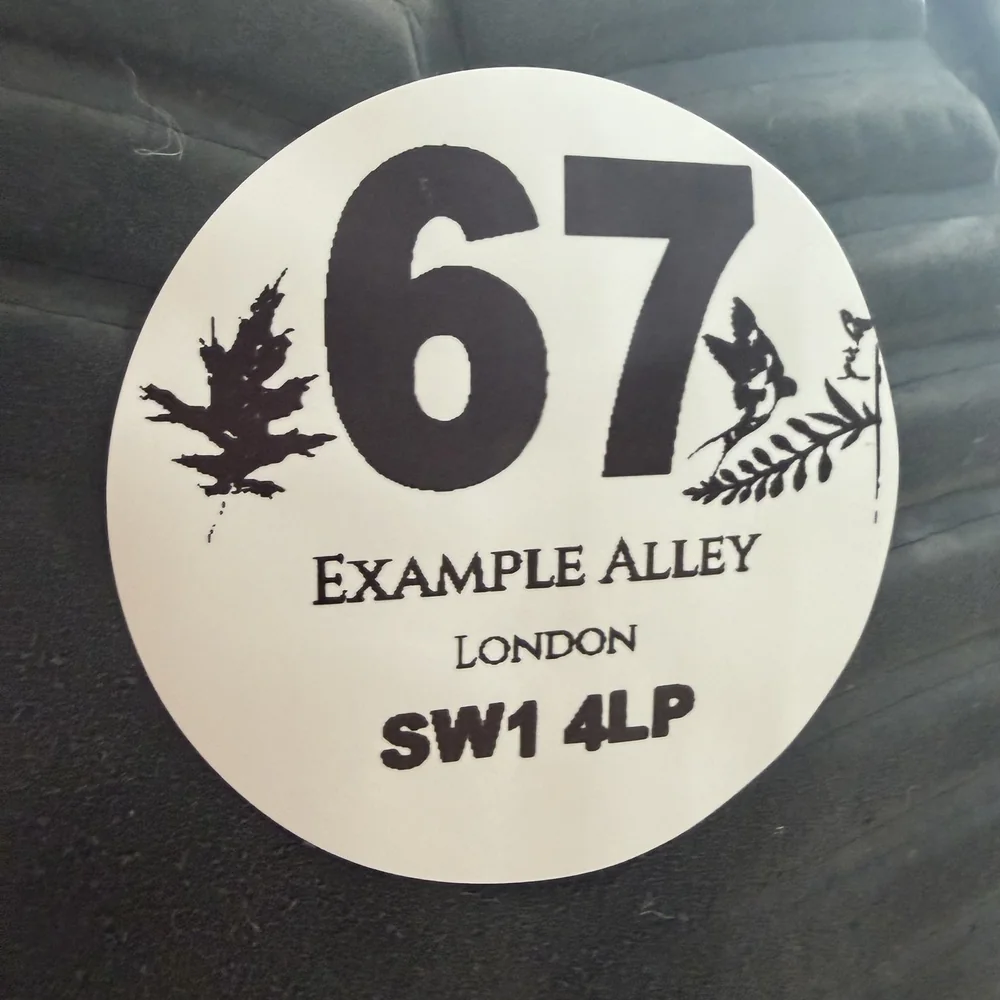 Close-up of one round personalised sticker stuck to a bin surface